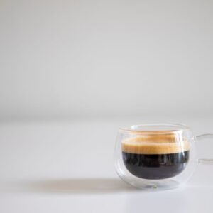 Simple and elegant espresso cup shot on a white background, highlighting the coffee's crema.