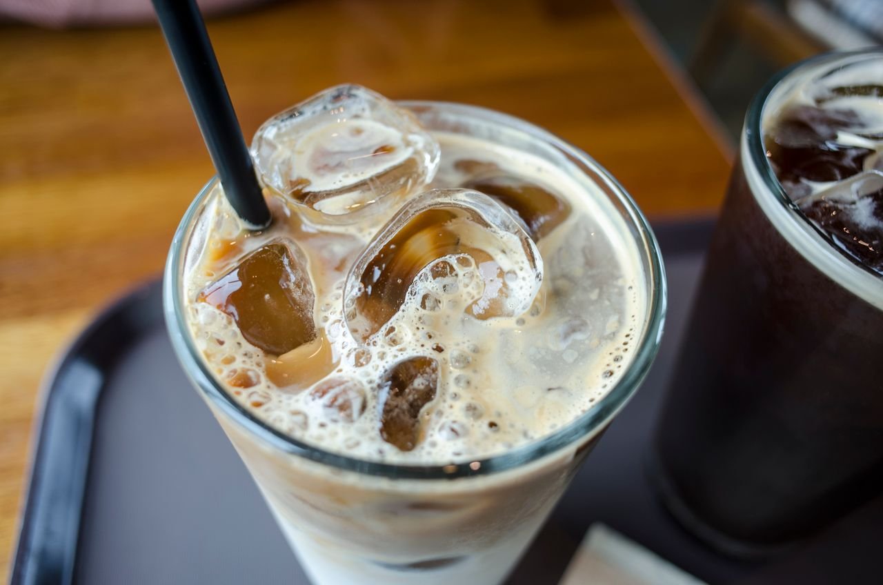 pexels photo 8980388 8980388 Close-up of a delicious iced milk tea with visible ice cubes and a straw.